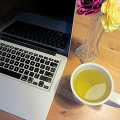 MacBook and a cup of green tea