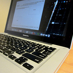 MacBook Pro displaying a wireframe of a website